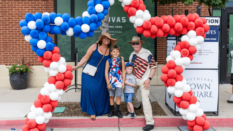 Family posing with a red white and blue star